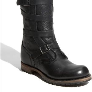 Black leather mid height boots.